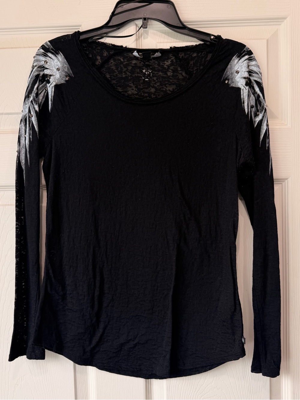 Black Long-Sleeve Women's Top with Painted Wing Shoulder Detail